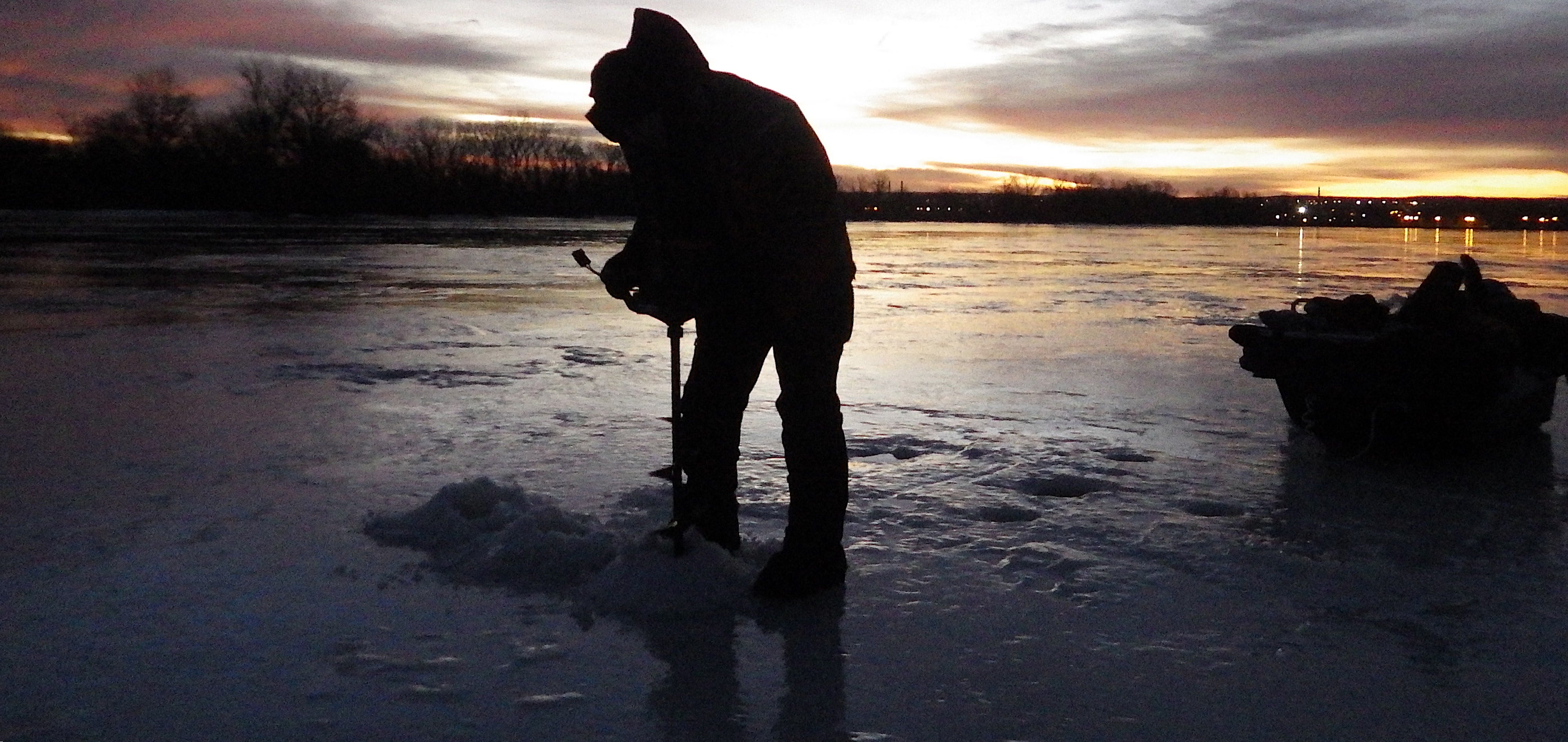 drilling ice fishing hole