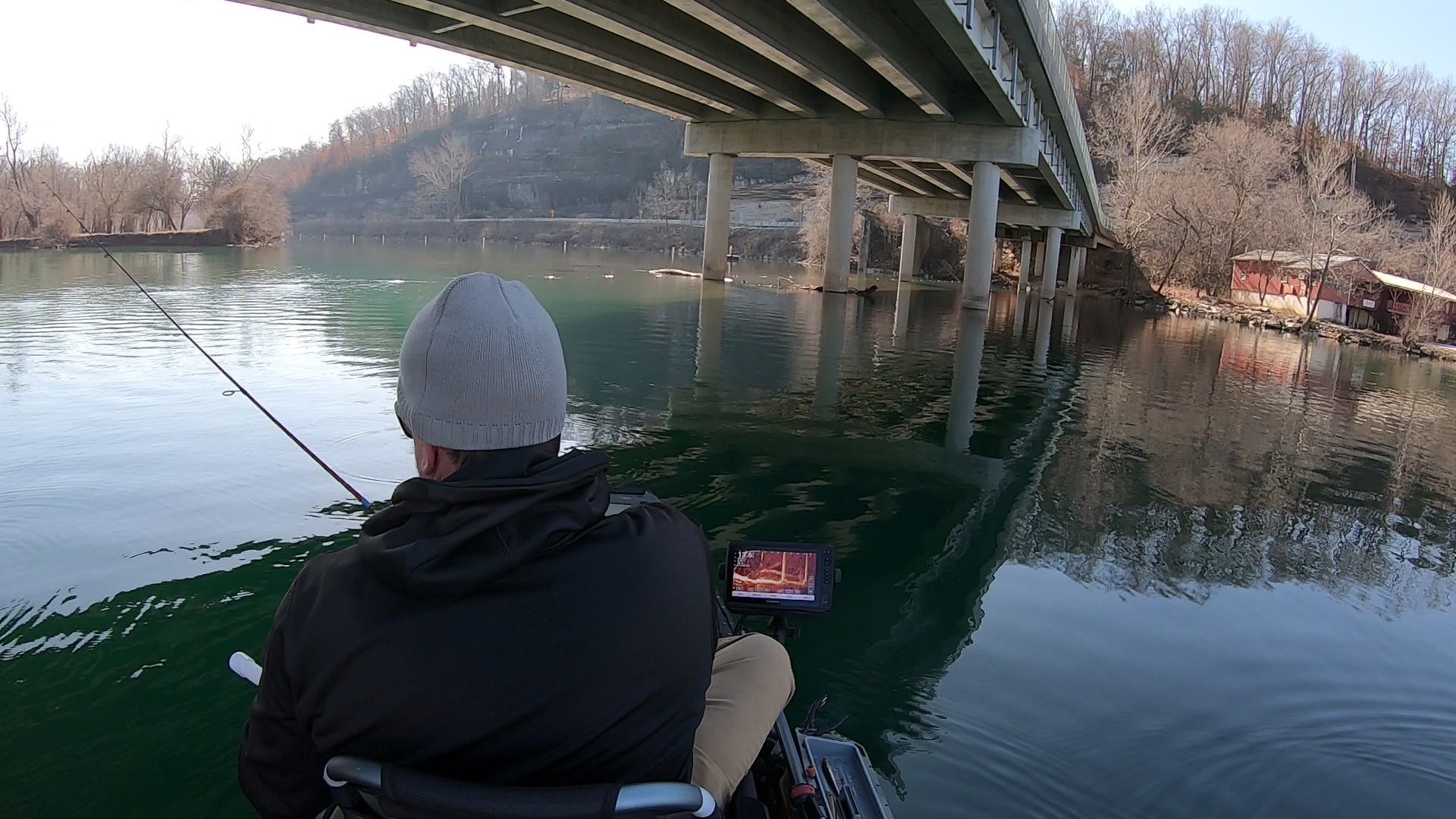 kayak fishing under bridge